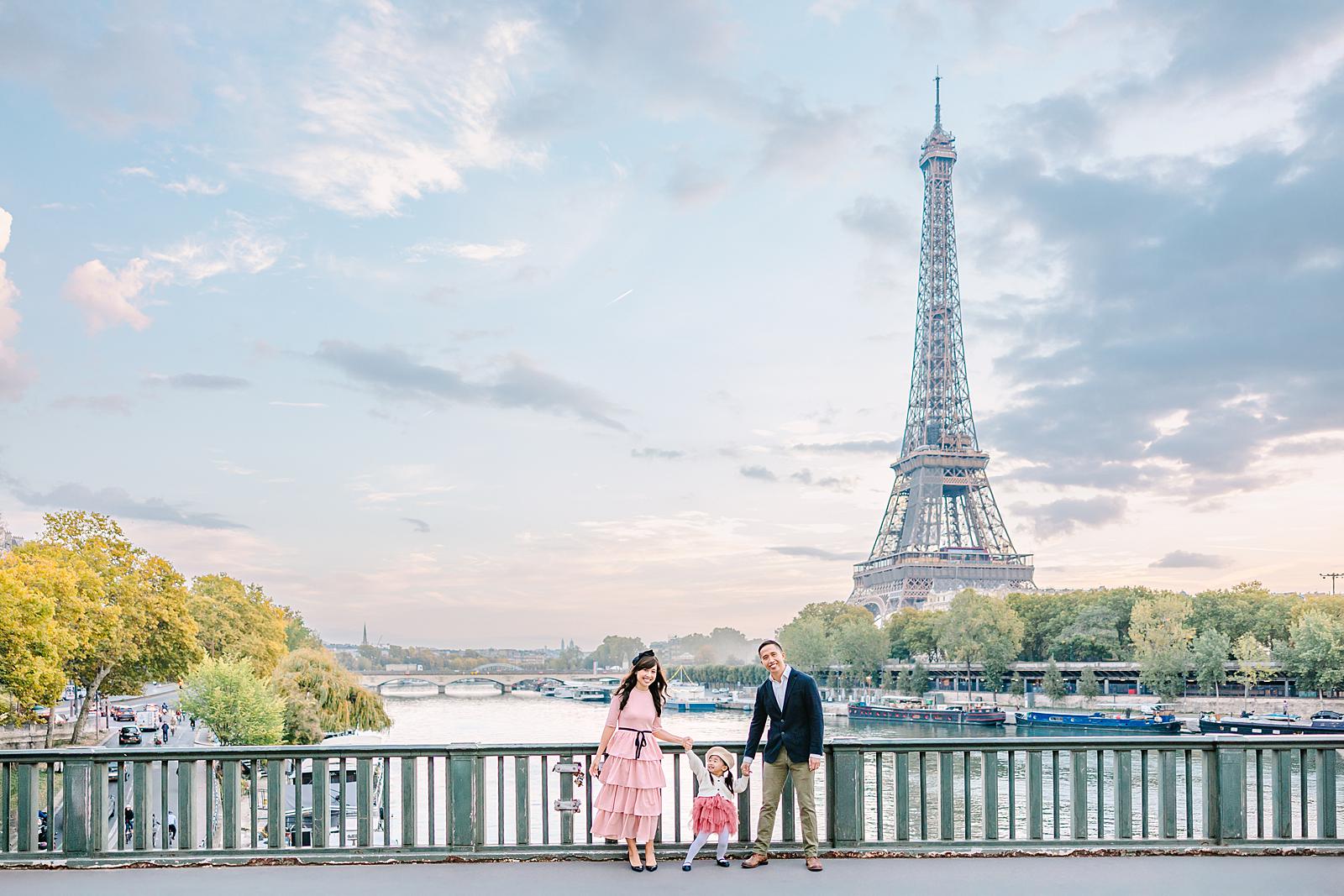 Wide shot of a family with Eiffel Tower and Seine River in the background